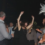 Guests having a good time dancing with Samba dancers at a cocktail party. 