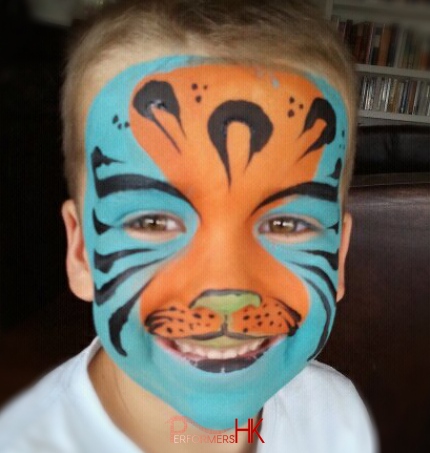 A Little Boy in HK asked a face painter draw a special blue and orange tiger face paint at a family fun day event