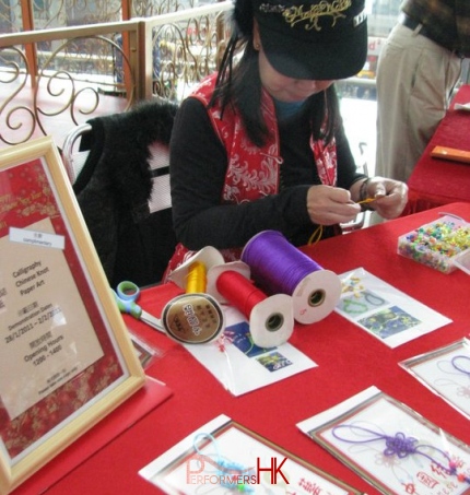 A Hong Kong Chinese knot artist knitting at a corporate CNY event