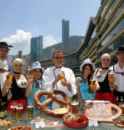 Four dancers in Hong Kong wearing German traditional costume posing for the Hong Kong Jockey Club Oktoberfest event