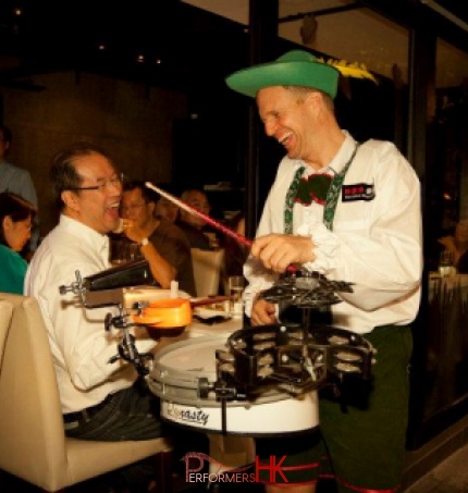 Drummer performing in restaurant, laughing with guests