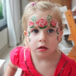 A lovely rose crown face paint.