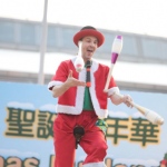 Unicyclist performing three cups juggling on the unicycle at Hong Kong Shopping center corporate Christmas Carnival event