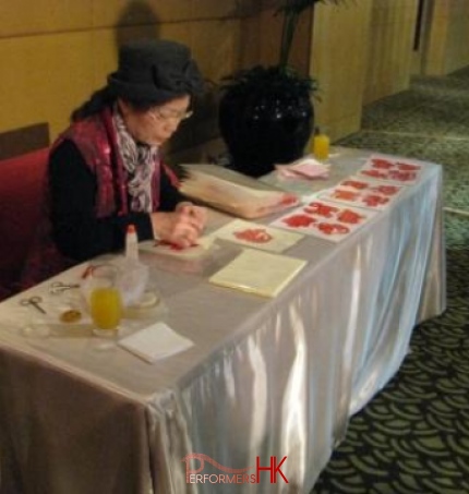 artist with table in costume chinese traditoal craft work