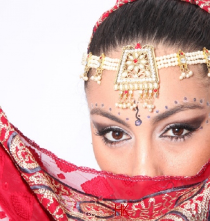 A head shot of a Bollywood Dancer in Hong Kong wearing Red traditional Bollywood dance costumes for a cocktails event