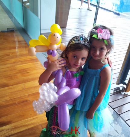 HK roving balloon clown twisted a Ariel balloon for two kids at a princess theme event