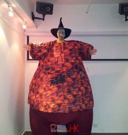 Stilt walker in HK wearing a witch hat ,scary mash and giant inflatable orange costume with Bat and spider for a corporate Halloween event