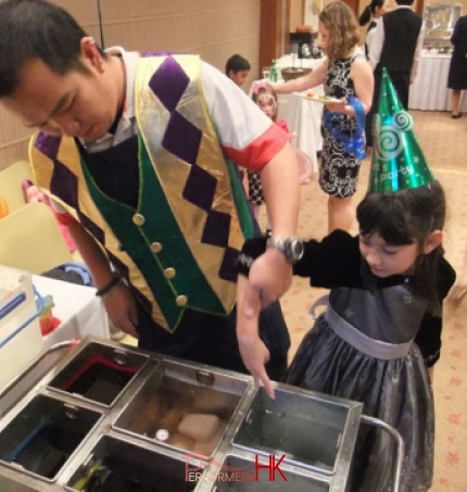 A Hong Kong kid making wax hand in a birthday party