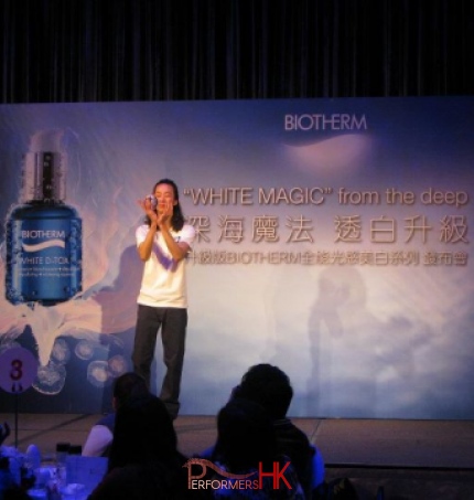 Contact juggler performing a stage show with a crystal ball at Hong Kong Biotherm product launch function