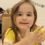 This little girl chose a blue sparkles nail art.