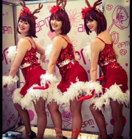 Three reindeer girl dancers in Hong Kong posing at the APM shopping mall Christmas event