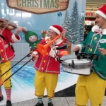 The grooves dressed in our custom made elf costumes playing at the Hong Kong International Airport .
