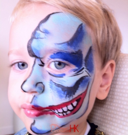 A little boy choose a Two-face face painting at a Halloween event in Hong Kong  