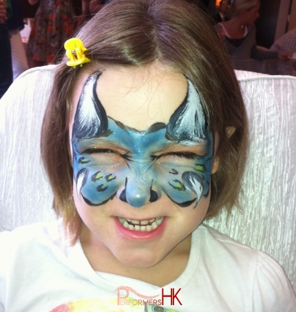 child with blue devil facepainting