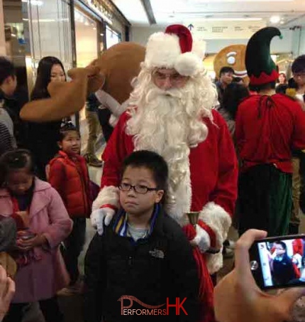 Santa in Hong Kong Sogo hotel having picture taken with child.