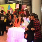 A living table dressed as an angel lit up with LEDS all over her body