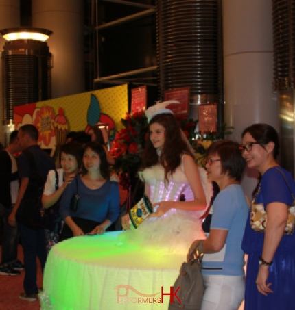 A lady dressed as a living table for corportate entetainment having picture taken of her