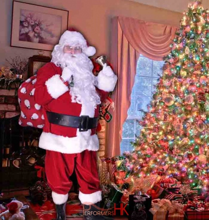Hong Kong professional Santa standing next to a Xmas tree ,taking promote photo for corporate xmas event.