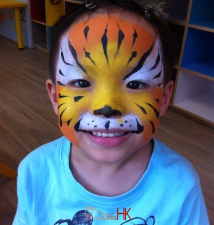 A children birthday party guest have a tiger face paint which draw by a face painter in HK