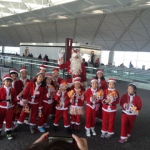 Santa Rowan at the Airport with littel santa helpers