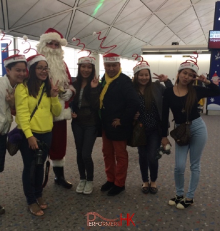 Santa at airport with guests in different clothes