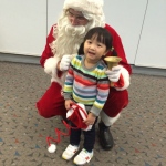 Santa with small child at the airport