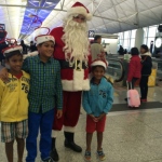 Santa with kids at the airport next to the travellators 