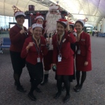 Tall Santa Rowan with Cathay flight staff at the airport boarding gates