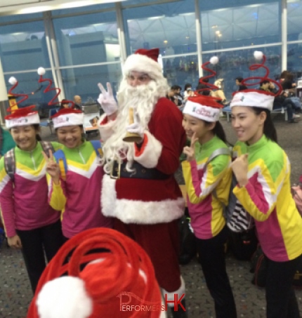 Santa at airport with guests with free gifts 