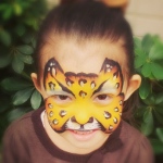 Leopard face paint on a little girl.