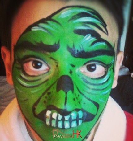 Hong Kong well-known face painter  draw a scary face paint on a boys face at a Halloween corporate event