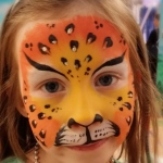 Leopard face paint with sparkle stickers.