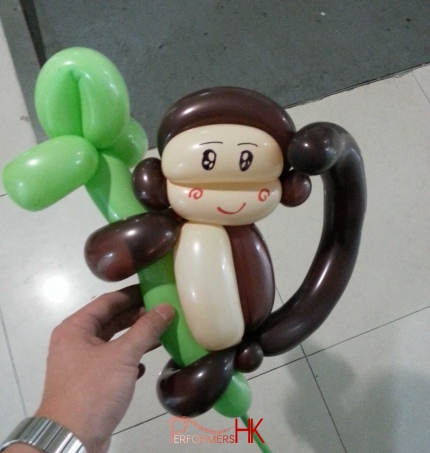 Hong Kong walk around magician holding a balloon monkey which climbing on a balloon tree at a corporate event