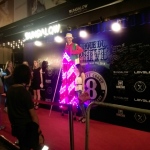 Led stilt walker standing outside nightclub in Hong Kong with model