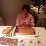 Hong Kong artist knitting Chinese knotting at a corporate event