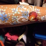 Flower and butterfly paint on arm.
