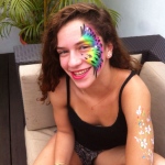 Rainbow color peafowl pattern face paint.