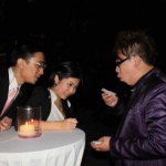 Magician in Hong Kong performing roving magic to two guests at a corporate cocktail event