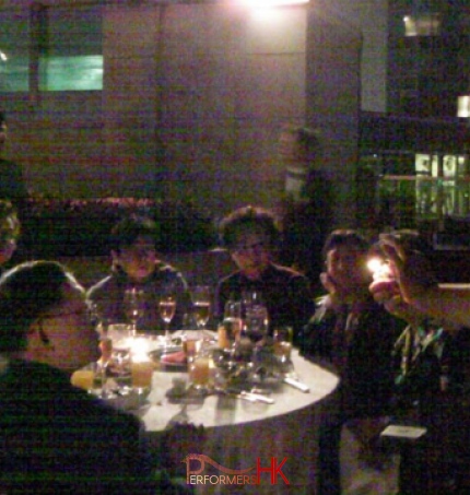Magician in HK performing roving fire magic in front of a table of guests at a corporate dinner event 
