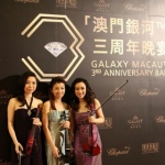 Violinists in Hong Kong taking photo in front of the backdrop before the Galaxy Macau 3RD Anniversary Ball start