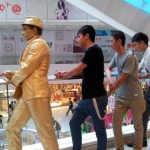 Golden statue performer having fun with visitors at the APM mall Kwun Tong, Hong Kong.