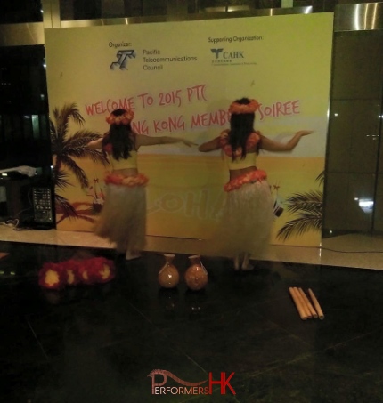 2 dancers doing the hula in front of backdrop for event in Hong Kong
