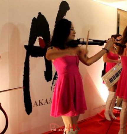 Four musician in Hong Kong wearing pink, performing with electric instrument at a restaurant opening event