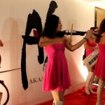 Four musician in Hong Kong wearing pink, performing with electric instrument at a restaurant opening event