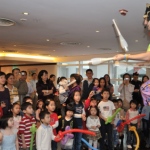 Benn unicycling at a kids party.