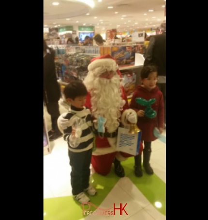 Santa in Hong Kong department store taking photos with children