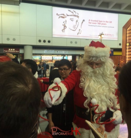 The Santa performer in HK giving out Christmas giveaway at the Hong Kong airport Xmas Event.