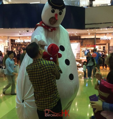 giant snowman character shaking hand with baby in hong kong