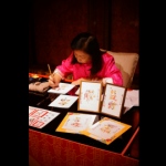 Professional Chinese calligrapher writing on Chinese style banners. 