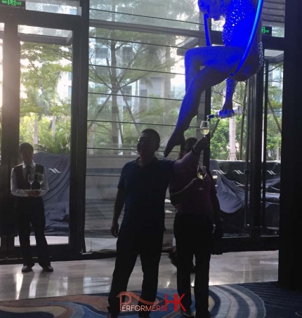 Performers serve champagne in aerial champagne performance in Hilton Shenzhen